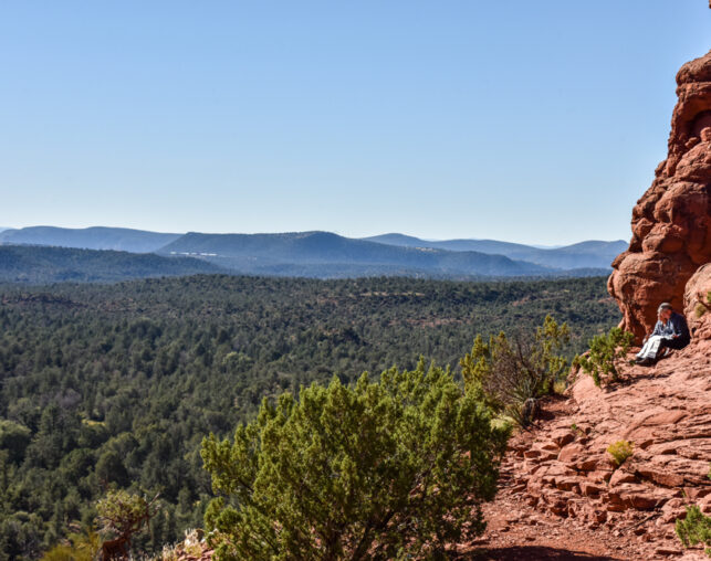 couple looking at map on red rocks