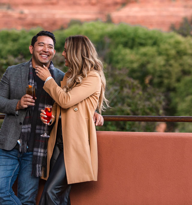 couple with cocktails in hand