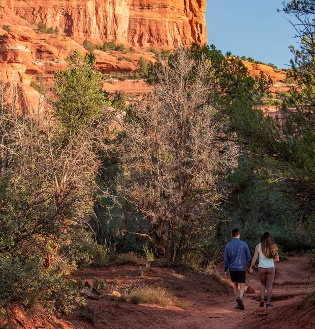 sunset hike in sedona, two people holding hands